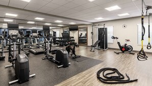 A gym with treadmills, weight machines, and free weights. - Hampton Inn & Suites Olean (Olean)