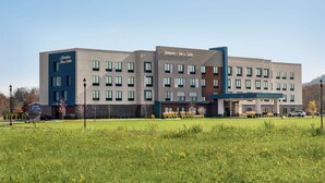 A modern hotel with a flat roof, multiple windows, and a sign indicating it is a Hampton Inn & Suites. - Hampton Inn & Suites Olean (Olean)