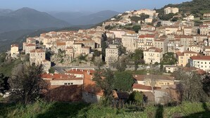 A town with historic buildings, a prominent church, and a hillside backdrop. - Rent a villa overlooking the Gulf of Valinco (Sartène)