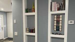 A hallway with grey walls, white shelving units, and a vent on the lower wall. -  Loft 902 with Sunsets from the 14x32 covered deck almost every morning! (Estevan)