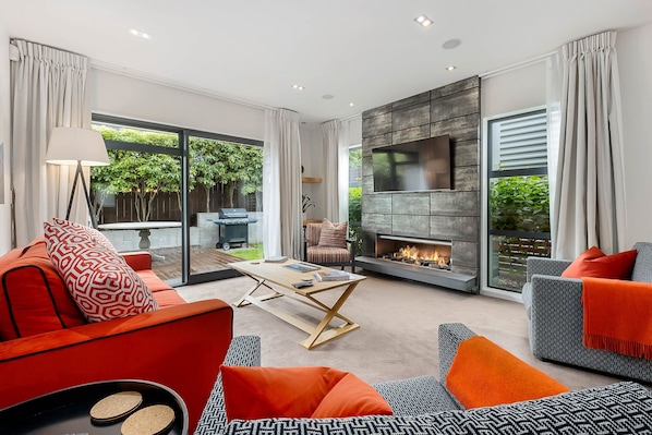 Villa | Living area | 50-inch Smart TV with satellite channels, TV, fireplace - Central Queenstown 3-Bed Villa by Staysouth (Queenstown)