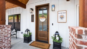 A wooden door with a welcome mat, a bench, and a sign for The Caddy Shack. - Putting Green,  Lakeviews, Indoor Pool,Pickleball (Branson)