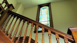 A wooden staircase with a stained glass window in the background. - Rest & Reignite at The Pulpit House -see video-KING BED - Whole Building PRIVATE (Hagaman)