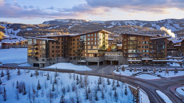 A multi-story hotel with a modern architectural design, featuring large windows and balconies. - Ski-in/out, Best Views, Best Location at Snowmass Base Village | One Snowmass (Snowmass Village)