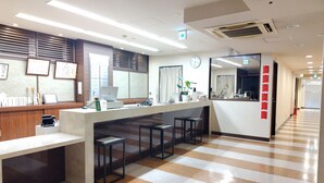 A reception area with a counter, a clock, and a mirror. - Kyoto Central Inn (Kyoto)