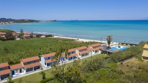 A coastal property with a swimming pool, beach access, and a view of the sea. - Villa Amorossa with Garden View & Shared Pool by Konnect, Roda Corfu (Corfu)