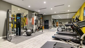 A modern gym with various exercise equipment, including treadmills, a stationary bike, and weight machines. - Hampton by Hilton High Wycombe (High Wycombe)