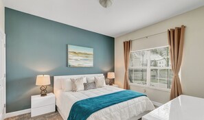A bedroom with a bed, nightstands, a window with curtains, and a painting on the wall. - 4BD/3BA Modern upgraded Townhome-private pool (Kissimmee)