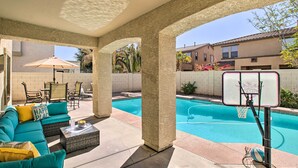A covered outdoor area with a pool, seating, and a basketball hoop. - Game Room, Putting Green! Queen Creek Family Home (Queen Creek)