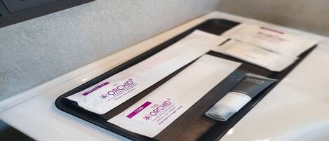 A tray with a skincare kit and a tube of lotion on a white countertop.
