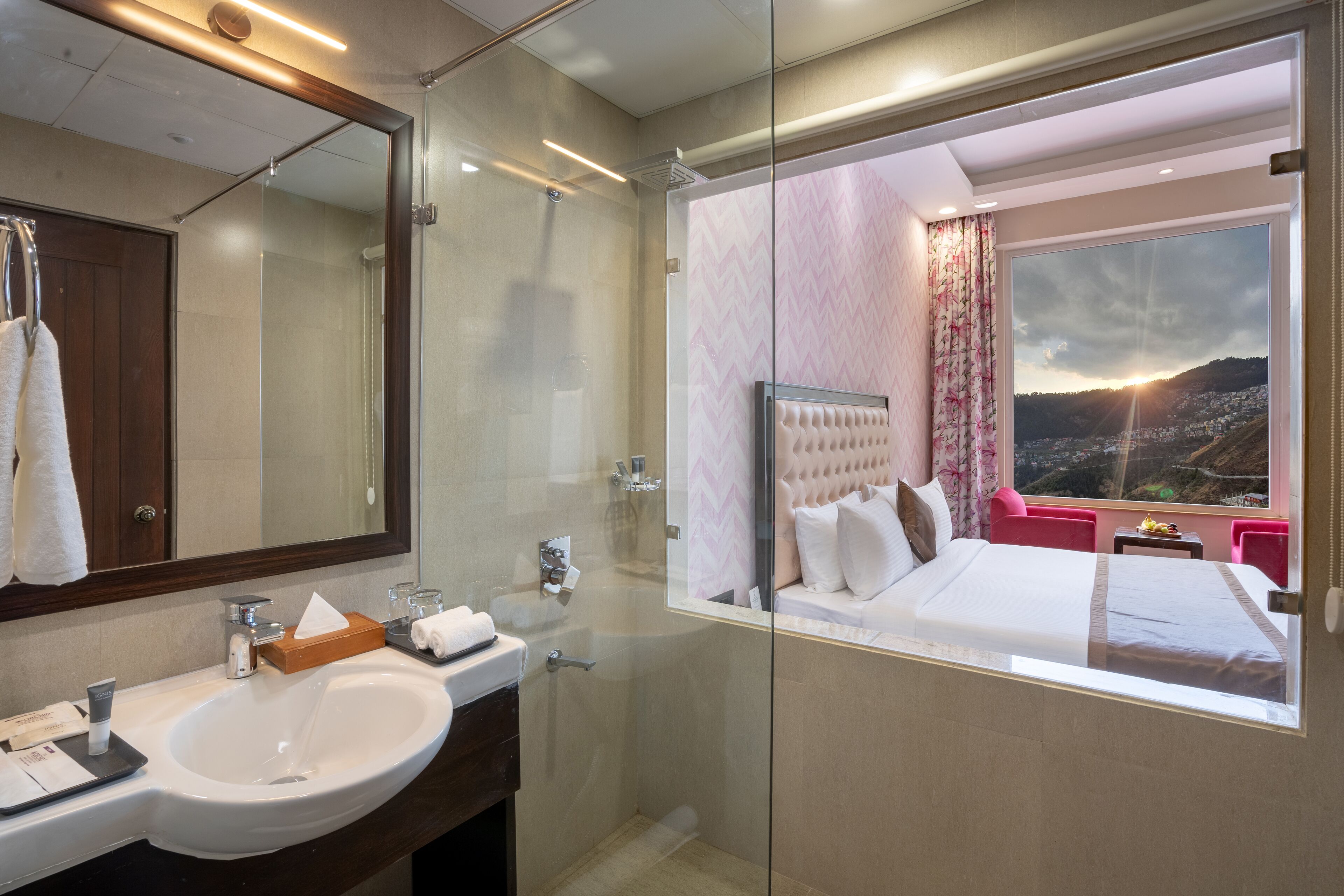 A modern bathroom with a large mirror, a sink, and a shower.