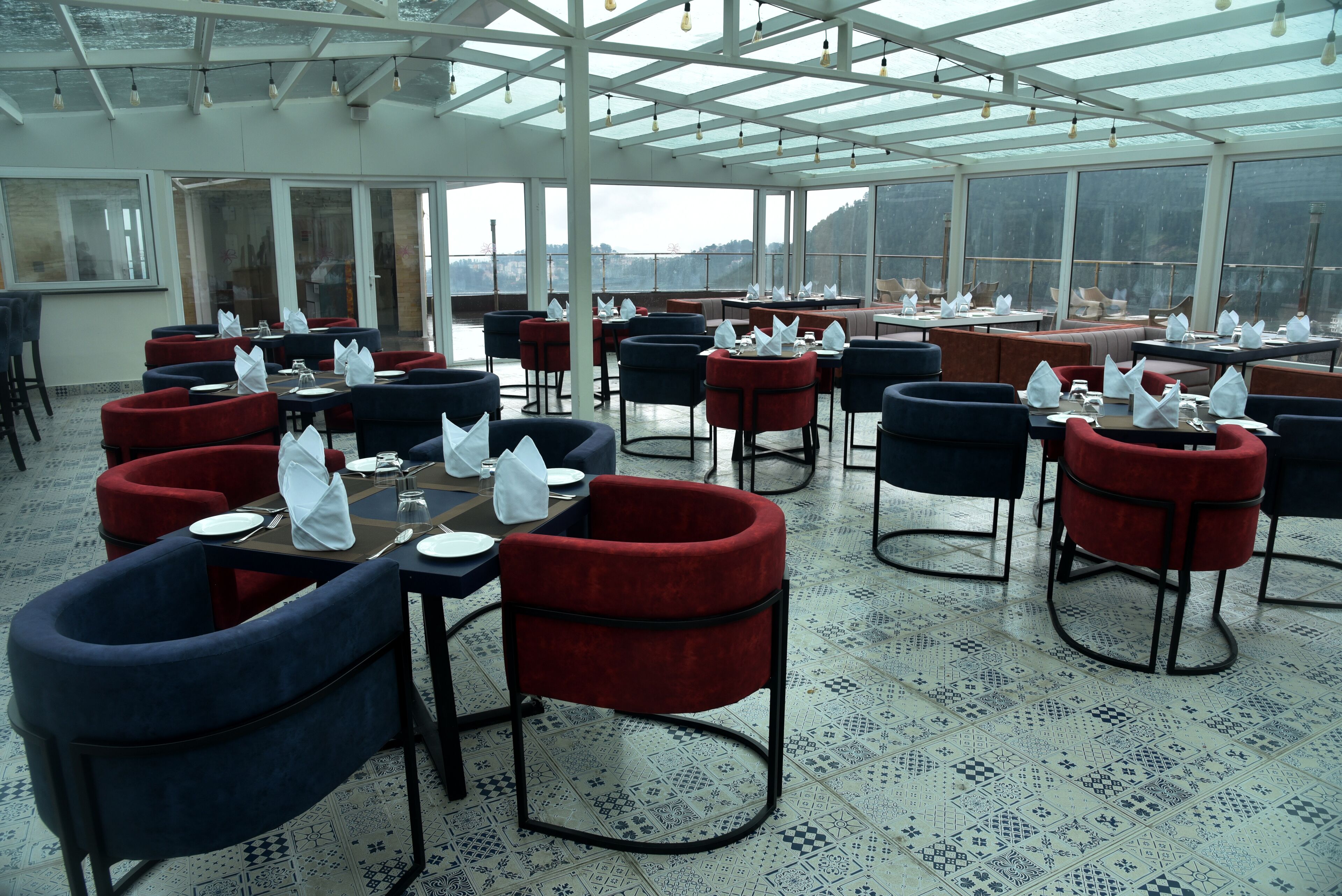 A restaurant with tables and chairs arranged for dining.