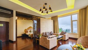 A spacious living area with a sofa set, a coffee table, and a decorative vase. - The Orchid Shimla (Shimla)