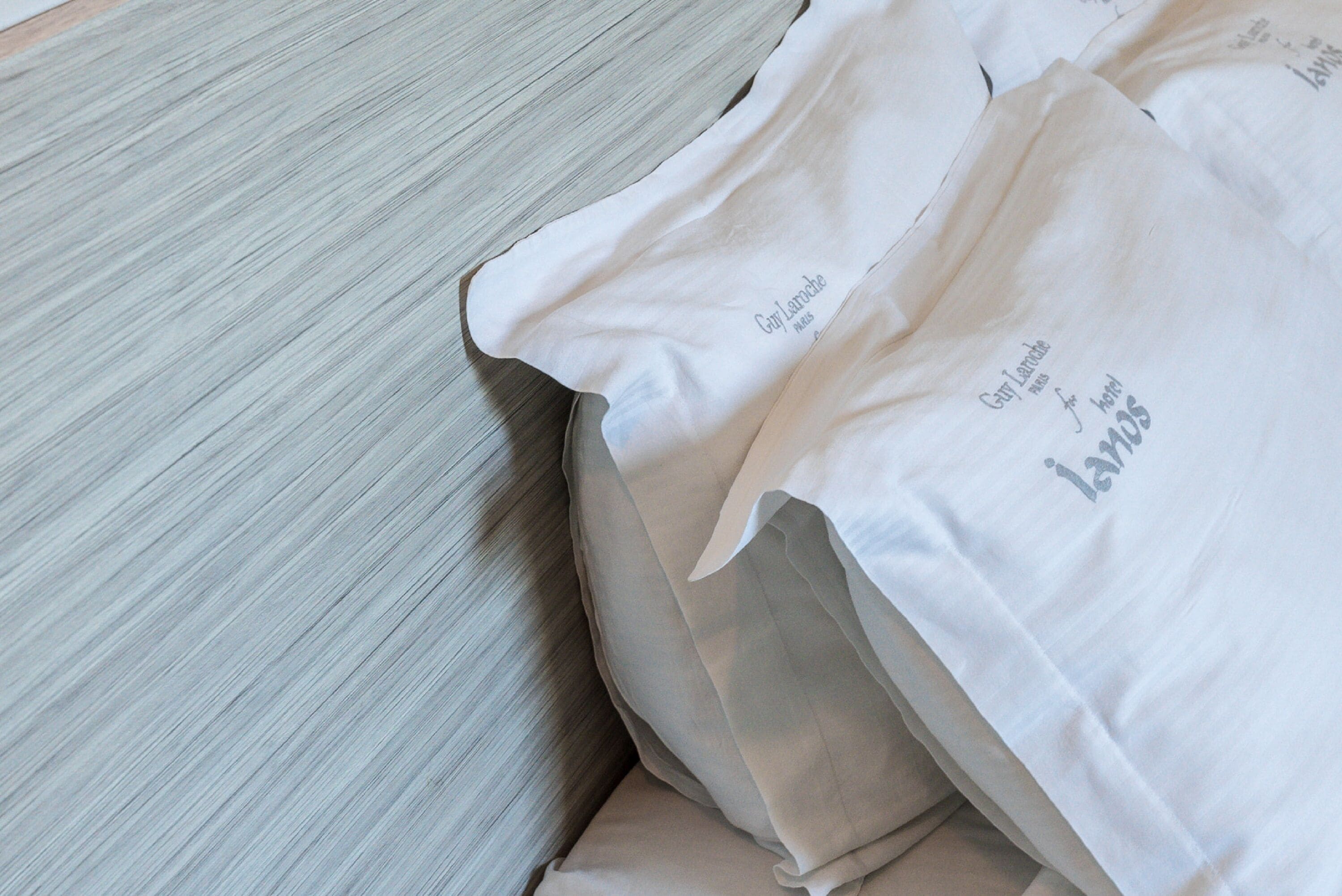 A white fabric with text on it, placed on a wooden surface.