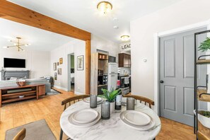A dining area with a marble table, grey plates, and candle holders. - Pine Street Retreat | 1BR Hot Tub Home, Dog Door, Walk to Main St | Leadville (Leadville)