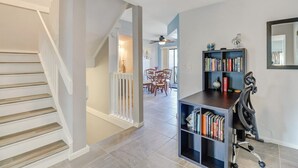A modern interior with a staircase, a dining area, and a bookshelf. - Paradise - quiet, clean, upgraded condo; walk to beach (Marco Island)