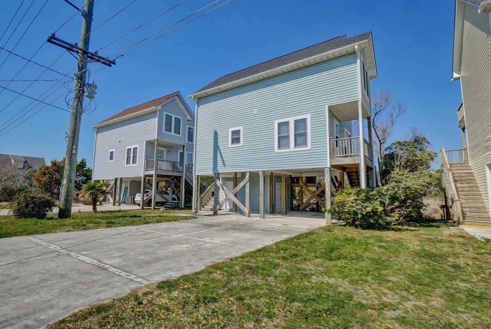A two-story residential building with a covered front porch and a garage.