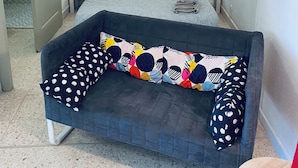 A bedroom with a bed, two bedside tables with lamps, a dark sofa with patterned cushions, and a tiled floor. - APPT 11 de la MAISON D'ANTONIN (Nîmes)