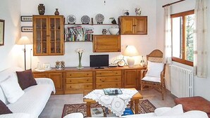 A cozy room with a bed, a desk with a computer, bookshelves, and a window with curtains. - Casa para familias en Ibiza (Sant Josep de Sa Talaia)