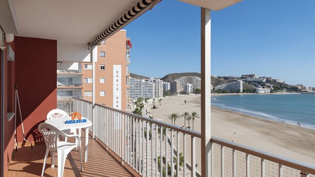 A balcony with a view of a beach and buildings. - EL RACO, A-7º-13 (Cullera)