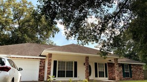 A single-story house with a brick facade, a garage, and a front lawn. - Newly Remodeled, Family Home, Near Interstate (Sulphur)