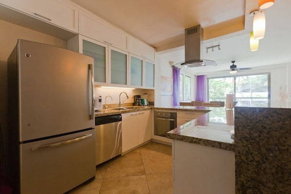 Enjoy cooking in this well-equipped kitchen with a refrigerator, dishwasher, and gas range.