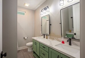 Combined shower/bathtub, towels, soap, toilet paper