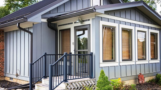 A house with a front porch, a small garden, and a brick foundation. - Welcome Race Fans! - Oversize Parking - Firepit - Mural - West Indy - Brownsburg (Indianapolis)
