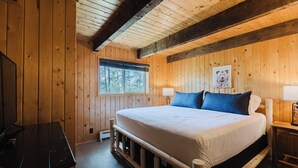 A wooden room with a bed, a desk, and a window. - Close to Wolf Creek, Fish San Juan River, Escape the Crowds (Pagosa Springs)