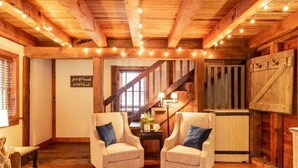 A cozy room with wooden beams, a staircase, and two armchairs. - 2 bedroom, 1.5 baths, full kitchen, comfortable living space with free parking (Palmyra)