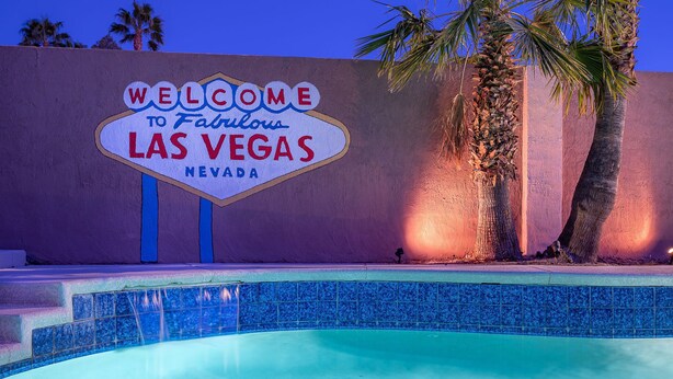 A welcome sign to Fabulous Las Vegas Nevada with a pool in the foreground.