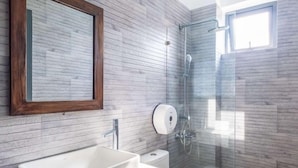 A modern bathroom with a large sink, toilet, and glass shower enclosure. - Richy Hotel (Da Lat)