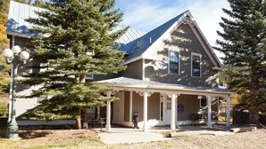 A two-story house with a covered porch and a large tree in front. - By the River - In Town - On The River - Backyard Fishing Spot - Free WiFi - Cabl (Red River)