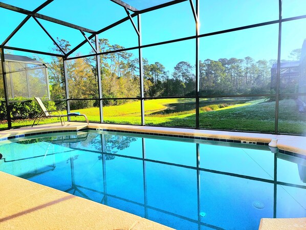 A swimming pool with a clear view of the surrounding landscape through large windows. - -BIG DISNEY FAMILY HOME-Priv Pool, Arcade, Lake Views, 4b/4ba. Close to Parks (Kissimmee)