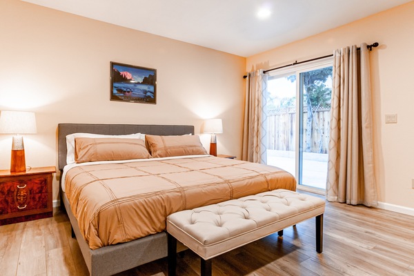 Huge master bedroom suite with one king size bed and a study desk.