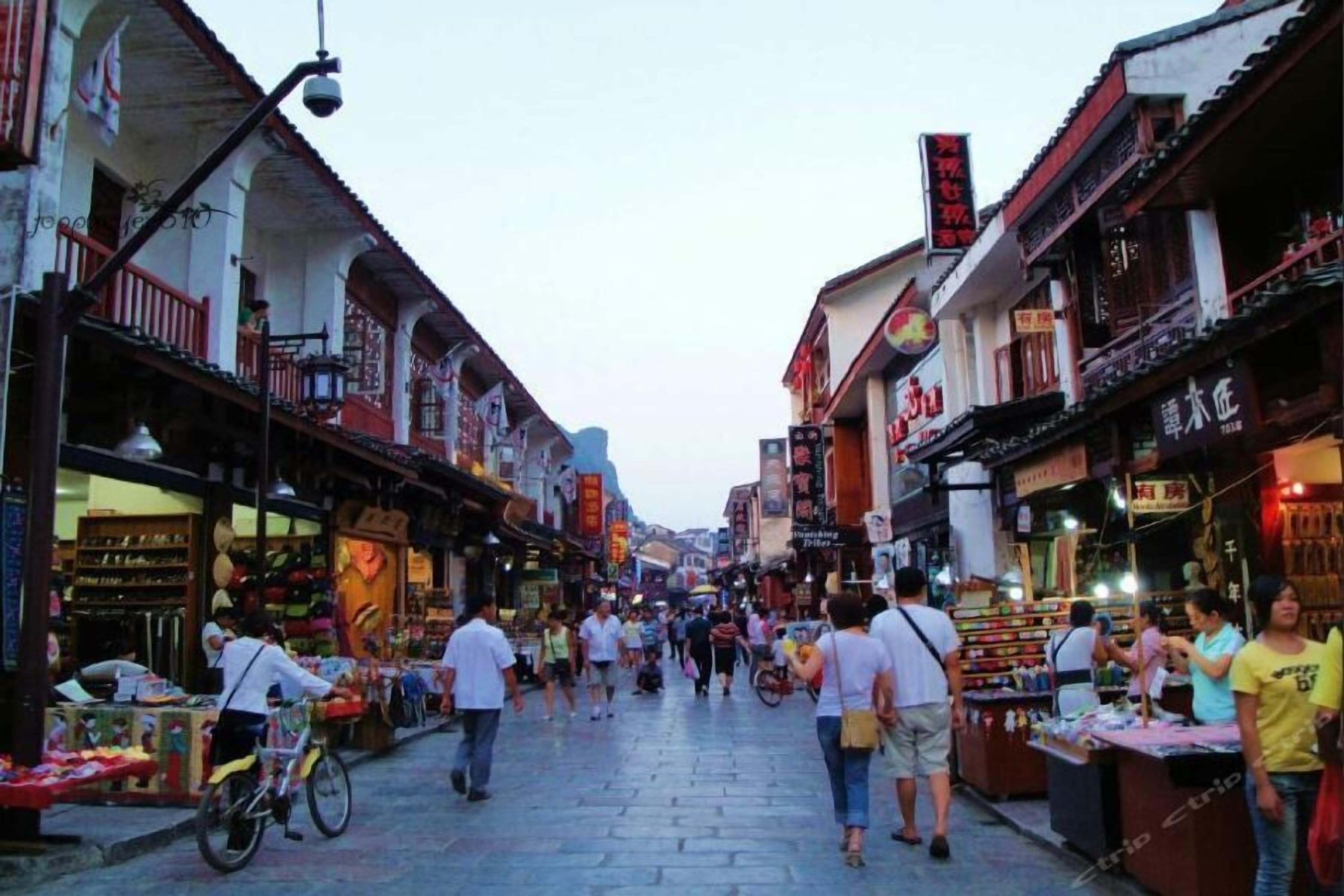 A bustling street market with shops and vendors.