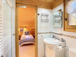 Bathtub, hair dryer, towels, toilet paper