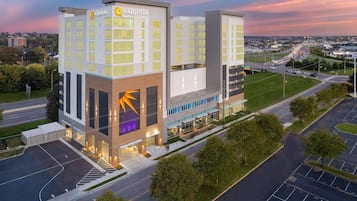 A modern hotel with a prominent 'La Quinta' sign, multiple floors, and a parking lot.