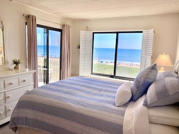 Relax in the master bedroom with beautiful ocean views and access to the balcony