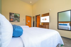 A hotel room with two beds, a television, and a framed picture on the wall. - SPOT X Hotel Orlando/Intl Dr by The Red Collection (Orlando)