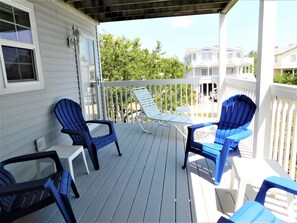 6 South Carolina Avenue - Elevated Coastal Balcony - Residents can enjoy the fresh Atlantic breeze from this secluded upper-level deck, furnished with classic blue Adirondack chairs. The white railing provides a crisp contrast against the coastal scenery.