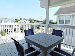 6 South Carolina Avenue - Upper-Level Outdoor Dining - This spacious upper-level balcony features a full dining set, providing the perfect venue for alfresco meals while enjoying elevated views of the Fenwick Island coastal landscape.