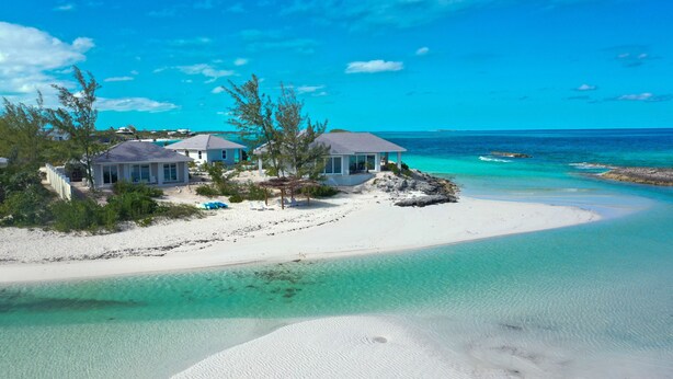 A beachfront property with two houses, a sandy beach, and clear turquoise waters. - Always Calm Beach. No Estate like this in Exuma! Brand New on protected sand bar (Little Exuma, Exuma)
