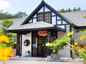 A traditional building with a tiled roof and a black and white facade.