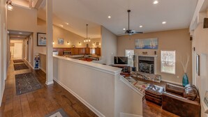 A spacious living area with a fireplace, a television, and a seating area with a sofa and ottoman. - Luxury 4BR Near Lake Pepin with Game Room - Breeze (Pepin)