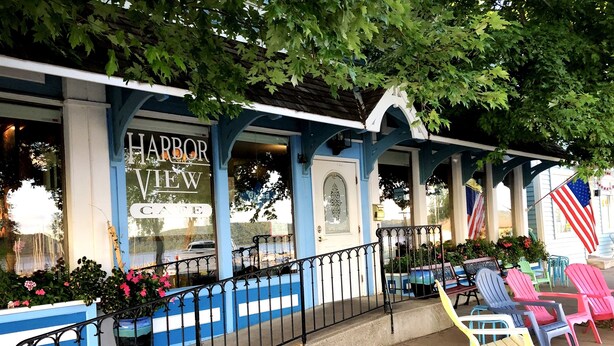 A Harbor View Cafe with outdoor seating and American flags. - Luxury 4BR Near Lake Pepin with Game Room - Breeze (Pepin)