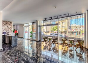 A hotel lobby with a reception desk, seating area, large windows, and a marble floor. - Dedem Hotel Express-Istanbul Airport (Arnavutköy)
