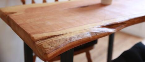 A wooden table with a potted plant on it.
