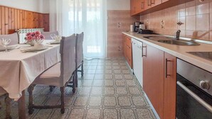 A kitchen with wooden cabinets, a countertop, and a sink. - Cosy apartment for 5 guests with WIFI, A/C, TV and terrace (Novi Vinodolski)