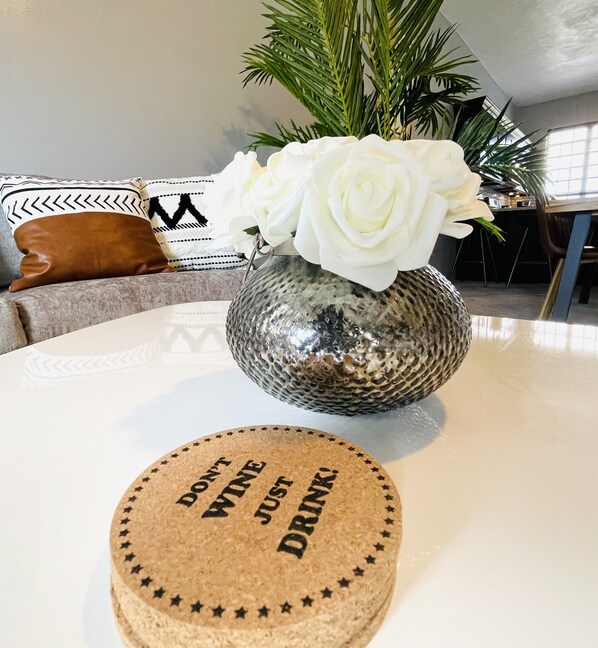 A round cork coaster with text on a table.